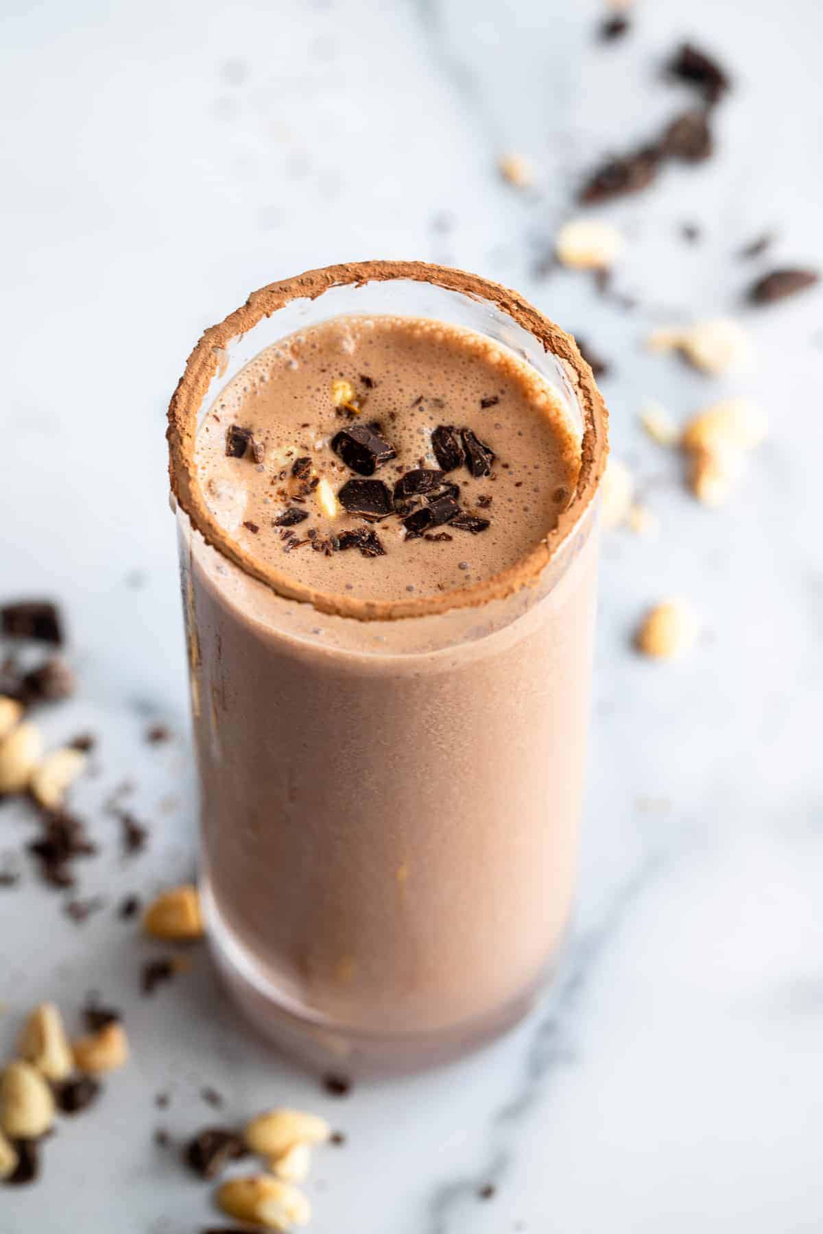 Chocolate Peanut Butter Protein Shake - A quick and easy protein Shake loaded with chocolate and peanut butter and NO protein powder! Perfect for a quick breakfast or snack! | #Foodfaithfitness | #glutenfree #dairyfree #healthy #breakfast a glass with a Chocolate Protein Shake on a table